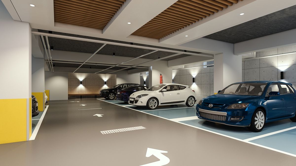 Moderne innendoers parkeringshus med parkerte biler